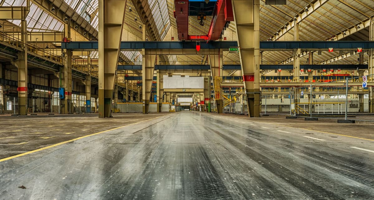Clean prepared concrete floor in an empty industrial warehouse