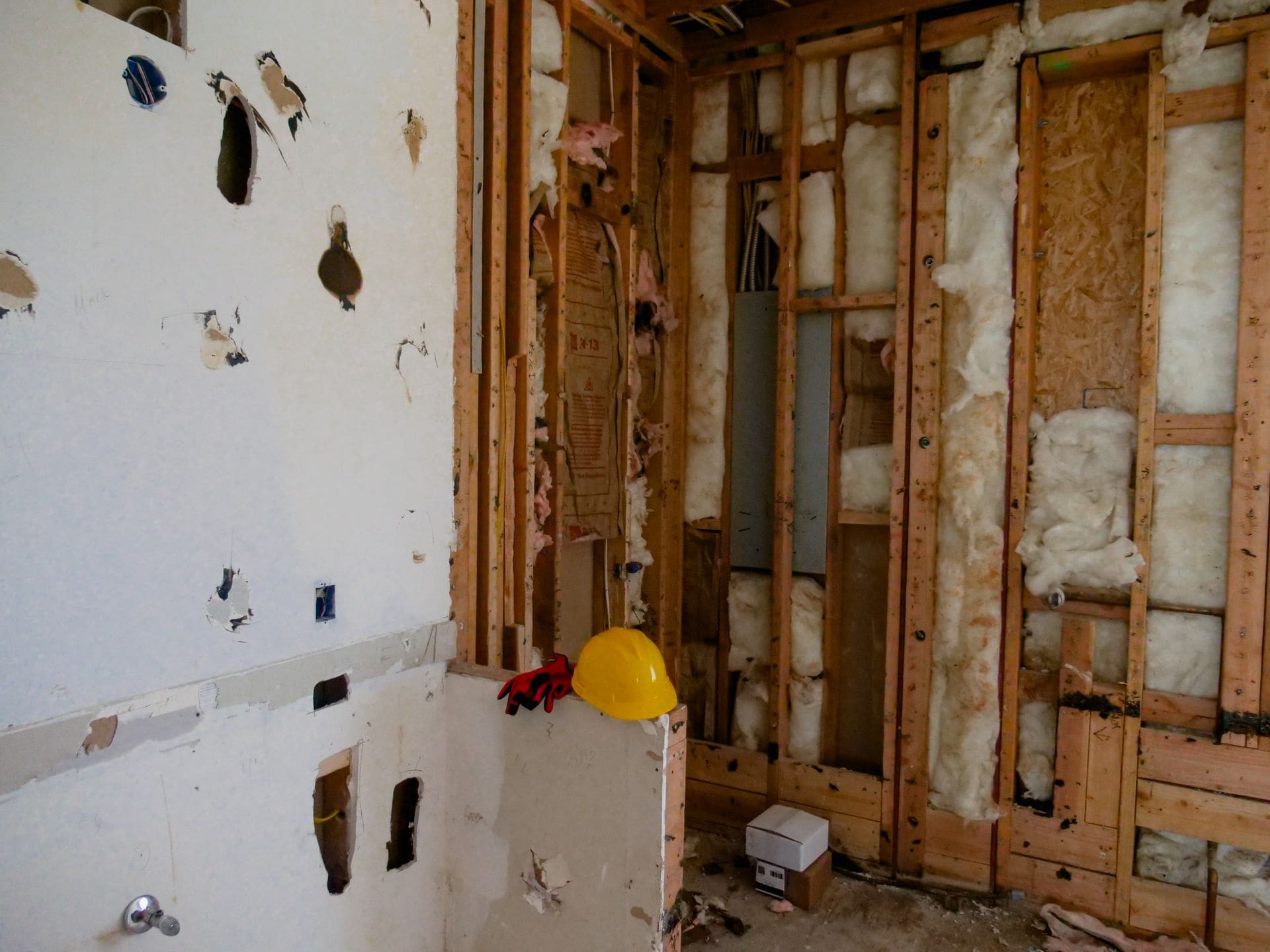 Commercial interior strip-out mid-demolition with partitions opened and ceiling grid removed