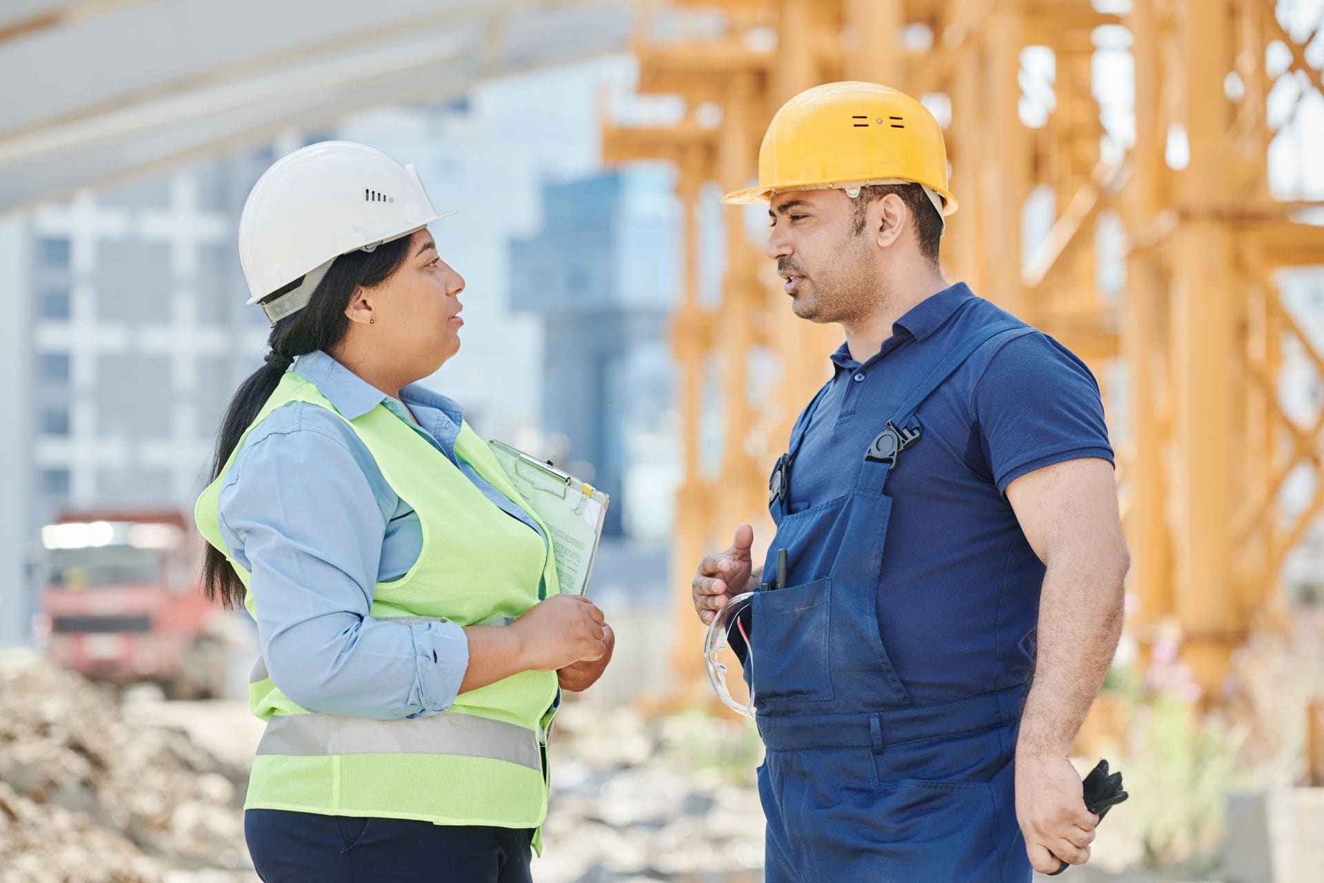 Contractor standing on a jobsite going over a demolition project plan on paper