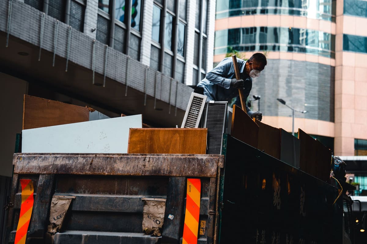 Crew hauling construction debris out of a commercial demolition site