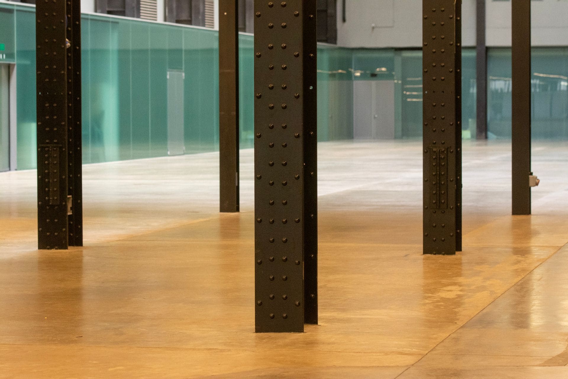 Open industrial space with steel columns and a bare concrete floor