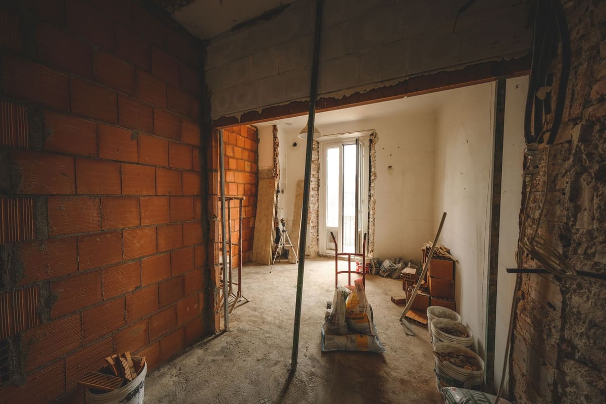 Interior demolition exposing original brick behind removed partition walls