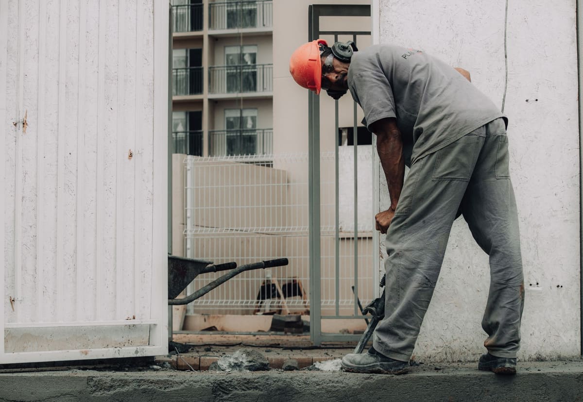 Jackhammer breaking out a section of concrete floor slab during demolition