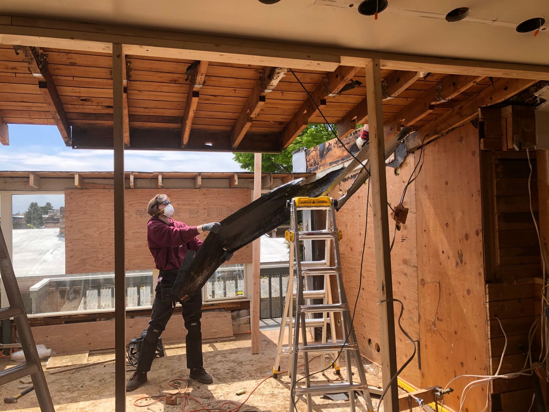 Worker removing interior material during a commercial renovation